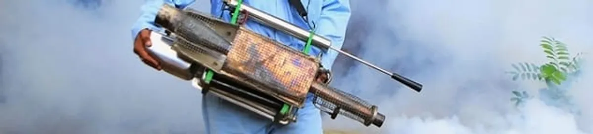 Fumigation technician using a fogger for deep pest treatment in Cambridge, MA